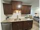 Updated kitchen boasts granite countertops, stainless steel dishwasher, undermount lighting and modern faucet at 2325 S Linden Ct # 211, Denver, CO 80222