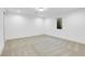 Bright finished basement room with carpeted floor and window at 5576 E Lehigh Ave, Denver, CO 80237