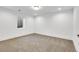 Spacious finished basement room with carpeted floors and a window at 5576 E Lehigh Ave, Denver, CO 80237