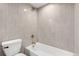 Simple bathroom with light grey tile and gold fixtures at 5576 E Lehigh Ave, Denver, CO 80237