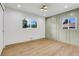 Light and airy bedroom with light wood flooring and a sage green accent wall at 5576 E Lehigh Ave, Denver, CO 80237