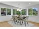 Modern dining room with large windows and a stylish light fixture at 5576 E Lehigh Ave, Denver, CO 80237