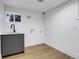 Basement laundry room with utility sink and gray cabinets at 5576 E Lehigh Ave, Denver, CO 80237