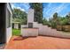 Outdoor patio area with built-in brick grill and red brick pavers at 5576 E Lehigh Ave, Denver, CO 80237