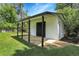 White shed with black trim and covered patio at 5576 E Lehigh Ave, Denver, CO 80237