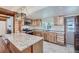 Modern kitchen with wood cabinets, granite counters, and stainless steel appliances at 483 Tonn Vly, Evergreen, CO 80439