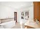 Bright bathroom with a soaking tub, decorative windows, and modern fixtures at 5030 W 33Rd Ave, Denver, CO 80212