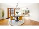 Elegant dining room with hardwood floors, a modern chandelier, and ample natural light at 5030 W 33Rd Ave, Denver, CO 80212