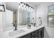 Modern bathroom featuring double sinks, black hardware, and contemporary lighting at 5068 E Crestone Ave, Castle Rock, CO 80104
