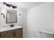 Well-lit bathroom with modern vanity and unique wood-grain cabinet at 5068 E Crestone Ave, Castle Rock, CO 80104