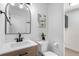 Modern bathroom featuring sleek fixtures, updated vanity, and a decorative mirror at 5068 E Crestone Ave, Castle Rock, CO 80104