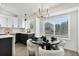 Bright dining area features a modern chandelier and a large window overlooking the neighborhood at 5068 E Crestone Ave, Castle Rock, CO 80104
