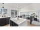 Kitchen island with white quartz countertop and an adjacent dining area at 5068 E Crestone Ave, Castle Rock, CO 80104