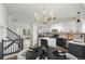 Modern kitchen featuring stainless appliances, island with white countertop and an adjacent dining area at 5068 E Crestone Ave, Castle Rock, CO 80104
