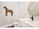 Chic half bathroom features stone wall accents, designer vanity and modern faucet at 2480 Castle Butte Dr, Castle Rock, CO 80109