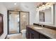 Bathroom featuring granite countertops, tile flooring, framed mirror, and walk-in shower at 2480 Castle Butte Dr, Castle Rock, CO 80109