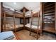 This bedroom features a built-in bunk bed, a shelf, and carpeted floors at 2480 Castle Butte Dr, Castle Rock, CO 80109