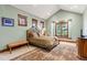 Cozy bedroom featuring a large window, vaulted ceiling, and comfortable carpeting at 2480 Castle Butte Dr, Castle Rock, CO 80109