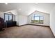 Spacious bonus room with bar, natural lighting, vaulted ceiling, and picturesque views at 2480 Castle Butte Dr, Castle Rock, CO 80109