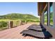 A sprawling deck is furnished with wicker loungers, offering a peaceful outdoor retreat at 2480 Castle Butte Dr, Castle Rock, CO 80109