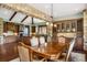 A spacious dining room with wood floors, stone archway, and natural light at 2480 Castle Butte Dr, Castle Rock, CO 80109