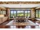 Elegant dining room featuring stone walls, wood floors, and scenic mountain views at 2480 Castle Butte Dr, Castle Rock, CO 80109