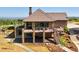 A two-story home boasts a deck, stone pillars, and a landscaped yard at 2480 Castle Butte Dr, Castle Rock, CO 80109