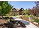 Charming home featuring stone accents, mature trees, and a beautifully landscaped walkway at 2480 Castle Butte Dr, Castle Rock, CO 80109