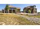 A two-story home boasts an entertainment area and landscaped yard with rock feature at 2480 Castle Butte Dr, Castle Rock, CO 80109