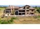 Beautiful stucco home with covered patios, stone accents, and mountain views at 2480 Castle Butte Dr, Castle Rock, CO 80109