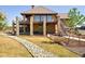 A two-story home boasts a deck, stone pillars, and a landscaped yard with rock feature at 2480 Castle Butte Dr, Castle Rock, CO 80109