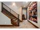 Hallway featuring modern stairwell with wood stairs, metal banister, and neutral wall tones at 2480 Castle Butte Dr, Castle Rock, CO 80109