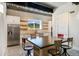 Modern kitchen with stainless steel appliances, white cabinetry, open shelves, and a large center island at 2480 Castle Butte Dr, Castle Rock, CO 80109