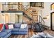 Stunning living room featuring hardwood floors, metal and wood staircase, and string lights at 2480 Castle Butte Dr, Castle Rock, CO 80109