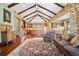 Open-concept living room with stone archways, vaulted ceilings, wood beams, and hardwood floors at 2480 Castle Butte Dr, Castle Rock, CO 80109
