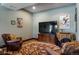 Cozy living room with leather armchairs, a patterned rug, console, and stylish wall art at 2480 Castle Butte Dr, Castle Rock, CO 80109