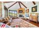 Inviting living room with a stone fireplace, large windows, and a beautiful view of the outdoors at 2480 Castle Butte Dr, Castle Rock, CO 80109