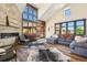 Bright living room featuring a modern fireplace, high ceilings, rustic accent wall, and a comfortable sectional sofa at 2480 Castle Butte Dr, Castle Rock, CO 80109