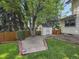 Charming backyard featuring a brick pathway, shed and mature trees at 2576 S Cody Way, Lakewood, CO 80227