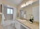 Bathroom featuring a double sink vanity, tub and shower combo, and a large mirror that maximizes the light at 2576 S Cody Way, Lakewood, CO 80227