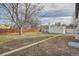 Spacious backyard featuring a mix of grass and dirt areas with perimeter fencing at 3780 Benton St, Wheat Ridge, CO 80212