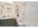 Well-lit bathroom featuring a vanity, toilet, and shower-tub combo at 3780 Benton St, Wheat Ridge, CO 80212