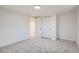 Bright bedroom features modern sliding closet doors and neutral carpet at 3780 Benton St, Wheat Ridge, CO 80212