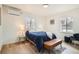 Stylish bedroom with hardwood floors, a modern bench, and updated lighting at 3780 Benton St, Wheat Ridge, CO 80212