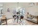 Dining area featuring modern lighting, hardwood floors, and seating for four at 3780 Benton St, Wheat Ridge, CO 80212
