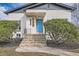 Inviting front porch with stairs leading to a vibrant blue door with transom window at 3780 Benton St, Wheat Ridge, CO 80212