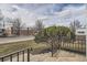 View from porch shows street, neighboring businesses and landscaped front yard at 3780 Benton St, Wheat Ridge, CO 80212