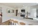Updated kitchen features white cabinets, marble countertops, and a breakfast bar with seating at 3780 Benton St, Wheat Ridge, CO 80212