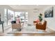 Bright living room with large windows, hardwood flooring, and contemporary furnishings at 3780 Benton St, Wheat Ridge, CO 80212
