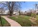 Large backyard with grass and a concrete walkway leading to a storage shed at 748 W 100Th Ave, Northglenn, CO 80260